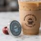 Personalized coffee shop stamp next to branded iced coffee cup
