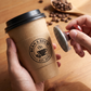 Custom cafe logo stamp with printed kraft coffee cup sleeves