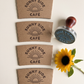 Personalized coffee cup stamp with custom business logo on kraft paper sleeve
